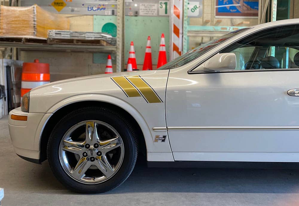 Gold vinyl decal on side of car